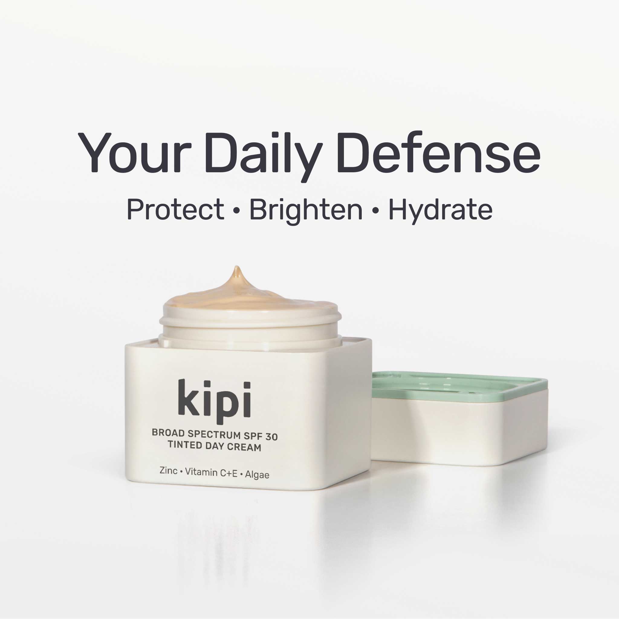 Kipi broad spectrum SPF 30 tinted day cream with text 'Your Daily Defense' on a white background
