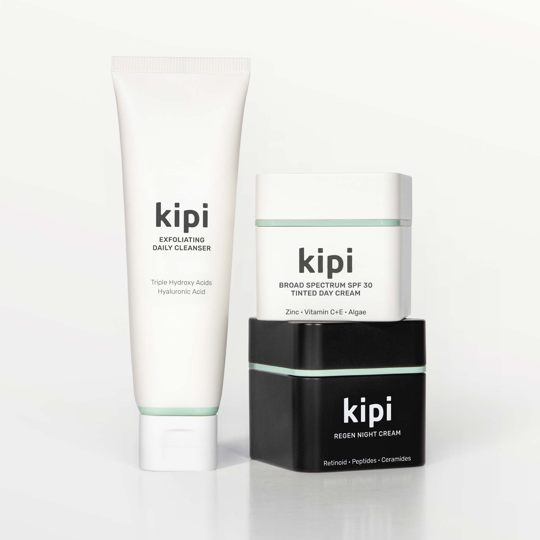 Kipi skincare products including a cleanser, day cream, and night cream on a white background