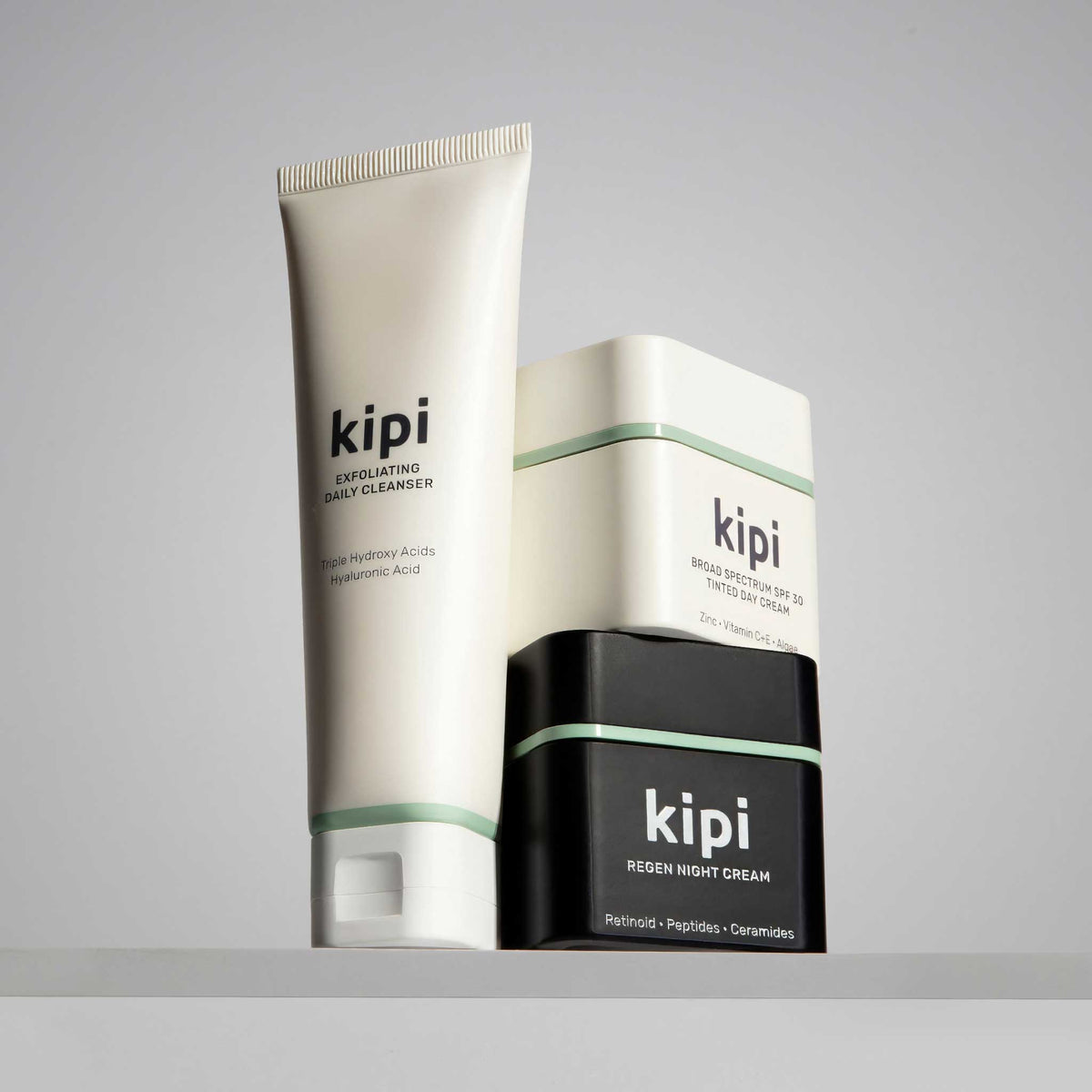 Kipi Exfoliating Daily Cleanser, Tinted SPF Day Cream, and Regen Night Cream.